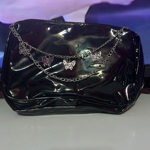 black latex hand bag with a butterfly chain/handle